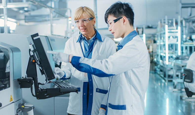 Download image (.jpg) (opens in a new window) Two doctors reviewing mammogram case
